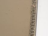 a picture of a mirror that is on the wall