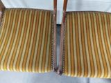 two wooden chairs with striped upholstered upholstered seats