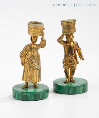 pair of brass figurines of women carrying pots on their heads
