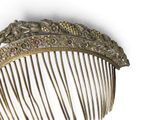 a gold comb with flowers and leaves on it
