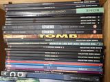 many dvds stacked on top of each other on a shelf