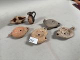 several pieces of pottery sitting on top of a table next to each other