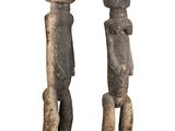 pair of carved wooden figures of a man and a woman