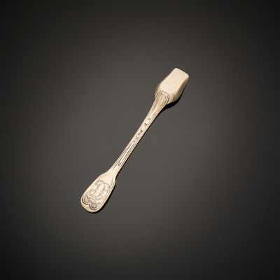 a close up of a spoon on a table with a black background