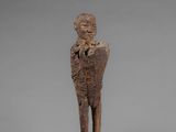 an image of a wooden statue of a man holding a baby