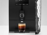 a coffee machine with a glass of coffee on top of it