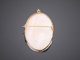 a gold and white pendant with a pink quartz stone