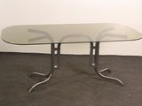 a glass table with metal legs and a glass top