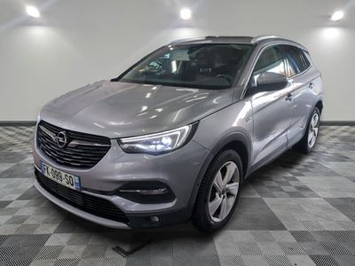the grey opel suv is parked in a room with a checkered floor