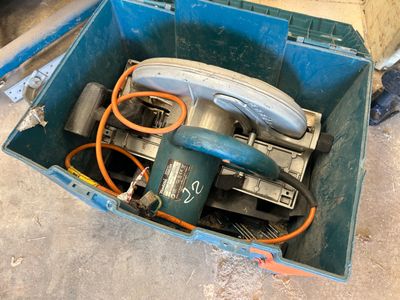 a blue box with tools inside of it on the floor