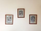 three framed pictures on the wall of a living room