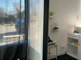 a bathroom with a shower, sink, and mirror in it