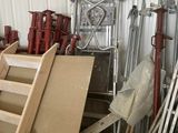 a room with a ladder, a chair, a chair, a table, and other items