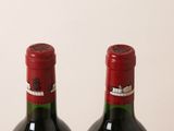 two bottles of wine sitting next to each other on a table