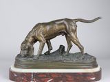 statue of a dog on a marble base on a white background