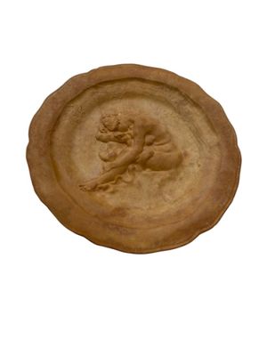 a clay plate with a picture of a man on it