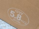 a brown box with a logo on it sitting on the ground