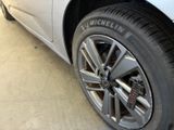 a close up of a tire on a car in a garage