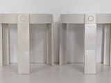 pair of white round side tables with drawers on each side