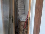 a mop that is sitting on the floor next to a stack of pizza boxes