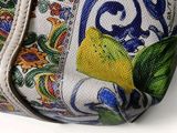 a white purse with a floral design on it