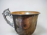 a silver cup that is sitting on a table