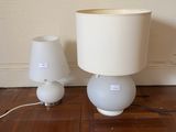 two lamps that are sitting on the floor next to each other