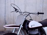 a white and black motorcycle parked on the side of the road