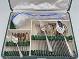 a green case with silverware in it on a table