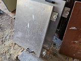 a metal door that has been left open on the ground