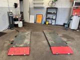 two red and black ramps in a garage