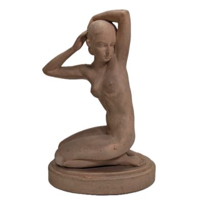 statue of a woman sitting on a base with her hands on her head