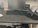 a desk with a computer and a phone on it