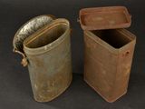 pair of old tin cans with lids and handles on a black background