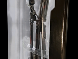 a silver clock inside of a clear box on a table