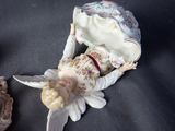 a figurine of a woman laying on the ground