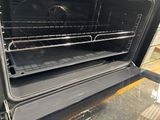 an open oven with a rack in the middle of it