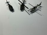 three model airplanes on a white surface next to each other