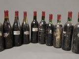 six bottles of wine are lined up in a row on a table