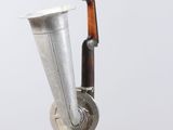 an old musical instrument hanging from the side of a pole