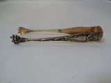 a silver spoon with a wooden handle on a white surface