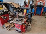 a machine that is sitting in a garage with a lot of tools
