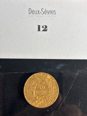 a close up of a gold coin on a black surface