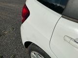a white car that is parked in a parking lot