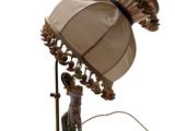 a lamp that is sitting on a table with a lamp shade on it