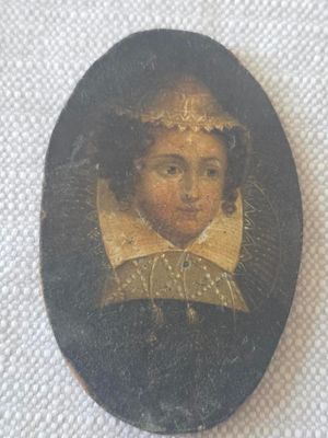 portrait of a young girl in a black dress with a gold collar around her neck