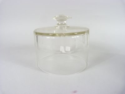 clear glass jar with gold trim and lid on a white surface