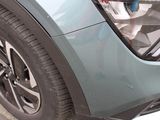 a close up of a car ' s front bumper with the door open
