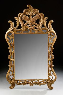 an ornately carved mirror is shown against a black background