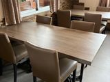 tables and chairs in a large room with a flat screen tv